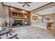 Cozy living room featuring a large custom entertainment center with fireplace and views of the kitchen at 42023 N Bridlewood Way, Anthem, AZ 85086