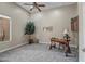 Comfortable and spacious living room with carpet, a ceiling fan, and a serene atmosphere at 42023 N Bridlewood Way, Anthem, AZ 85086