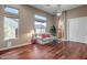 Inviting living room with hardwood floors, high windows, and a cozy seating area with clear glass tables at 42023 N Bridlewood Way, Anthem, AZ 85086