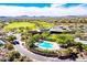 Aerial view of the community pool, surrounded by lush greenery and seating, with stunning mountain views at 42023 N Bridlewood Way, Anthem, AZ 85086