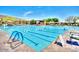 Community swimming pool featuring lap lanes, lounge chairs, and mountain views in the background at 42023 N Bridlewood Way, Anthem, AZ 85086