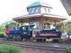 Daisy Mountain Railroad train replica with passenger car and decorative building on the grounds at 42023 N Bridlewood Way, Anthem, AZ 85086