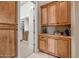 View of a walk-in closet with custom wood cabinets and shelves, offering ample storage space at 42023 N Bridlewood Way, Anthem, AZ 85086