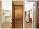 Hallway view of walk-in closets with custom wood and white shelving, maximizing storage at 42023 N Bridlewood Way, Anthem, AZ 85086
