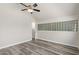 Bedroom with updated floors, a ceiling fan, and a unique glass block window, offering natural light at 4901 S Calle Los Cerros Dr # 220, Tempe, AZ 85282