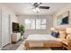 Comfortable bedroom with ceiling fan, large window, tv, and modern decor at 4901 S Calle Los Cerros Dr # 220, Tempe, AZ 85282