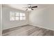 Comfortable bedroom with wood-look floors, neutral walls, and a ceiling fan, perfect for relaxing at 4901 S Calle Los Cerros Dr # 220, Tempe, AZ 85282