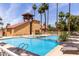 Community pool with palm trees, lounge chairs, and covered seating, perfect for relaxation and recreation at 4901 S Calle Los Cerros Dr # 220, Tempe, AZ 85282