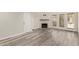 Inviting living room with a white brick fireplace, modern gray floors, and ample natural light at 4901 S Calle Los Cerros Dr # 220, Tempe, AZ 85282
