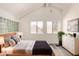 Bright primary bedroom features modern decor, vaulted ceilings, and large windows at 4901 S Calle Los Cerros Dr # 220, Tempe, AZ 85282