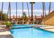 Resort-style pool with lush landscaping, pergola with lounge chairs, and blue tiled trim at 4901 S Calle Los Cerros Dr # 220, Tempe, AZ 85282