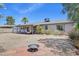 Backyard featuring a patio, firepit, desert landscaping, and mature trees for outdoor activities at 5133 E Keresan St, Phoenix, AZ 85044