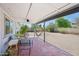 Backyard with covered patio, hammock, seating, and lush greenery for a serene outdoor experience at 5133 E Keresan St, Phoenix, AZ 85044