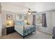 Bedroom features a decorative metal bed frame, ceiling fan, and modern decor for a cozy atmosphere at 5133 E Keresan St, Phoenix, AZ 85044