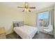 Bedroom with a large window for ample natural light, neutral carpet and simple decor at 5133 E Keresan St, Phoenix, AZ 85044