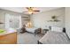 Bedroom featuring twin beds with decorative wall shelving, carpet and natural lighting at 5133 E Keresan St, Phoenix, AZ 85044