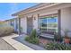 Inviting front porch featuring a bench and stylish landscaping with a security screen door at 5133 E Keresan St, Phoenix, AZ 85044