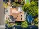 An overhead aerial view highlights the backyard pool, patios, basketball court, and terra cotta tile roof at 5556 E Sandra Ter, Scottsdale, AZ 85254