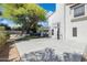 Spacious backyard featuring a basketball court, lush tree, and covered patio area at 5556 E Sandra Ter, Scottsdale, AZ 85254