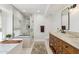 This full bathroom includes a spacious shower with a beautiful wood vanity at 5556 E Sandra Ter, Scottsdale, AZ 85254