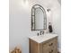 Stylish bathroom featuring a wood vanity, white countertop, and modern lighting fixtures at 5556 E Sandra Ter, Scottsdale, AZ 85254