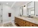 Spacious bathroom with dual sinks, wood cabinets, and a separate toilet room at 5556 E Sandra Ter, Scottsdale, AZ 85254