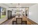 Bright dining room featuring a wooden table, modern chandelier, and access to the living area at 5556 E Sandra Ter, Scottsdale, AZ 85254