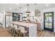 Modern kitchen with a large island, barstool seating, and updated appliances at 5556 E Sandra Ter, Scottsdale, AZ 85254