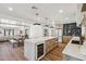 Open-concept kitchen with a large island, barstool seating, and a dining area at 5556 E Sandra Ter, Scottsdale, AZ 85254