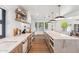 Open kitchen with a large island, modern appliances, stone countertops, and wood floors at 5556 E Sandra Ter, Scottsdale, AZ 85254