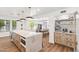 Bright kitchen features a large island, stone countertops, wood cabinets, and modern appliances at 5556 E Sandra Ter, Scottsdale, AZ 85254
