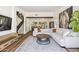 A bright living room with hardwood floors, a large sectional sofa, and an open concept design at 5556 E Sandra Ter, Scottsdale, AZ 85254
