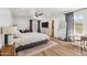Spacious main bedroom with a ceiling fan, walk-in closet, and wood-look flooring at 5556 E Sandra Ter, Scottsdale, AZ 85254