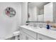 Charming bathroom features a granite vanity, white cabinets, grey flooring, and decorative mirror at 651 N Bay Dr, Gilbert, AZ 85233