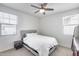 Bedroom featuring ceiling fan, a bed and two windows at 651 N Bay Dr, Gilbert, AZ 85233