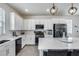 Modern kitchen with stainless steel appliances, white cabinets, and a large island with bar seating at 651 N Bay Dr, Gilbert, AZ 85233