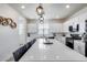 Well-appointed kitchen island featuring pendant lighting, sleek counter tops and barstool seating at 651 N Bay Dr, Gilbert, AZ 85233