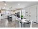 Bright kitchen boasts white cabinets, black appliances, a spacious island, and an adjacent dining area at 651 N Bay Dr, Gilbert, AZ 85233