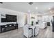 Open-concept living space with a cozy fireplace, dining area, and modern kitchen with black appliances at 651 N Bay Dr, Gilbert, AZ 85233