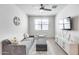 Neutral living room with grey sofa, ceiling fan, TV, chair and ottoman at 651 N Bay Dr, Gilbert, AZ 85233
