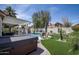 Spacious backyard featuring a pool, hot tub, and well-maintained artificial grass, perfect for outdoor living at 6732 W Sack Dr, Glendale, AZ 85308