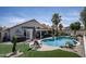 Relaxing backyard with a pool, hot tub, and well-manicured lawn, creating an ideal outdoor space at 6732 W Sack Dr, Glendale, AZ 85308