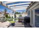 Cozy backyard with a covered patio, hot tub, and lush landscaping for relaxation and entertainment at 6732 W Sack Dr, Glendale, AZ 85308