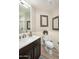 Cozy bathroom with marble countertops, brushed nickel faucet, wainscoting and framed botanical artwork at 6732 W Sack Dr, Glendale, AZ 85308