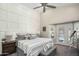 Stylish bedroom with a ceiling fan, large bed, and a door leading to the outdoor pool area at 6732 W Sack Dr, Glendale, AZ 85308