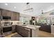 Stylish kitchen with granite countertops, stainless steel appliances, dark wood cabinets, and an open view to the pool at 6732 W Sack Dr, Glendale, AZ 85308