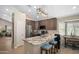 Kitchen island with granite countertop, seating, and stainless steel appliances provides a functional and stylish workspace at 6732 W Sack Dr, Glendale, AZ 85308