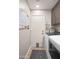 Functional laundry room with a modern washer and dryer, storage cabinets, and a convenient exterior door at 6732 W Sack Dr, Glendale, AZ 85308