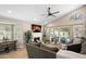 Bright living area with vaulted ceiling, white brick fireplace, and sliding glass doors leading to a beautiful pool area at 6732 W Sack Dr, Glendale, AZ 85308