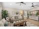 Comfortable living room with neutral tones, ceiling fans, stylish decor, and natural light at 6732 W Sack Dr, Glendale, AZ 85308